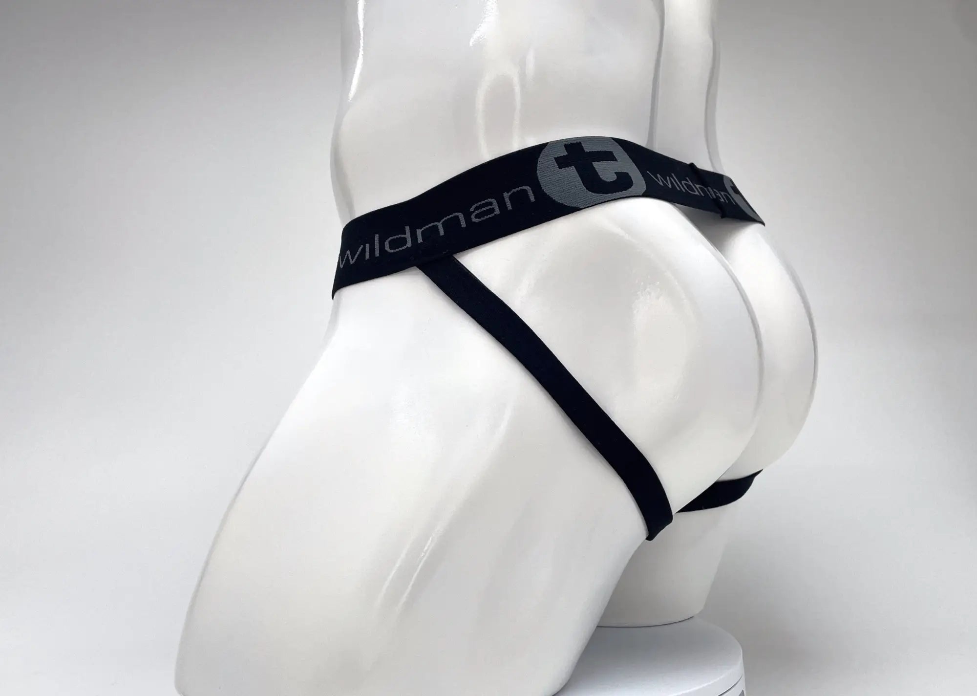 WildmanT black jockstrap with a branded waistband worn on a white mannequin torso, rear view.