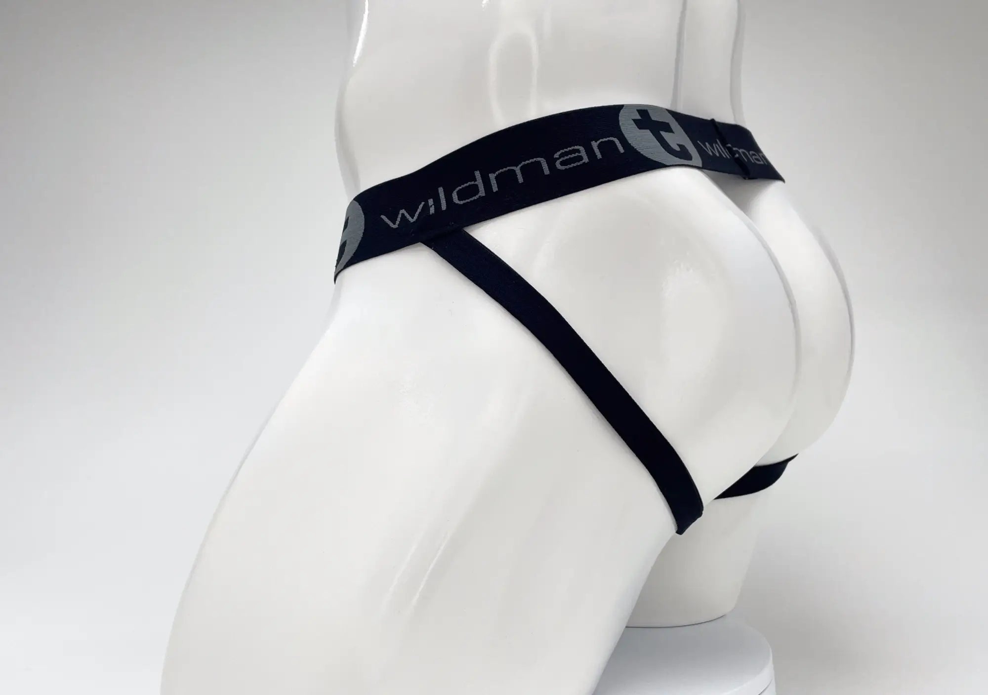 WildmanT jockstrap on a mannequin, featuring a black branded waistband with gray logo on a white studio background.