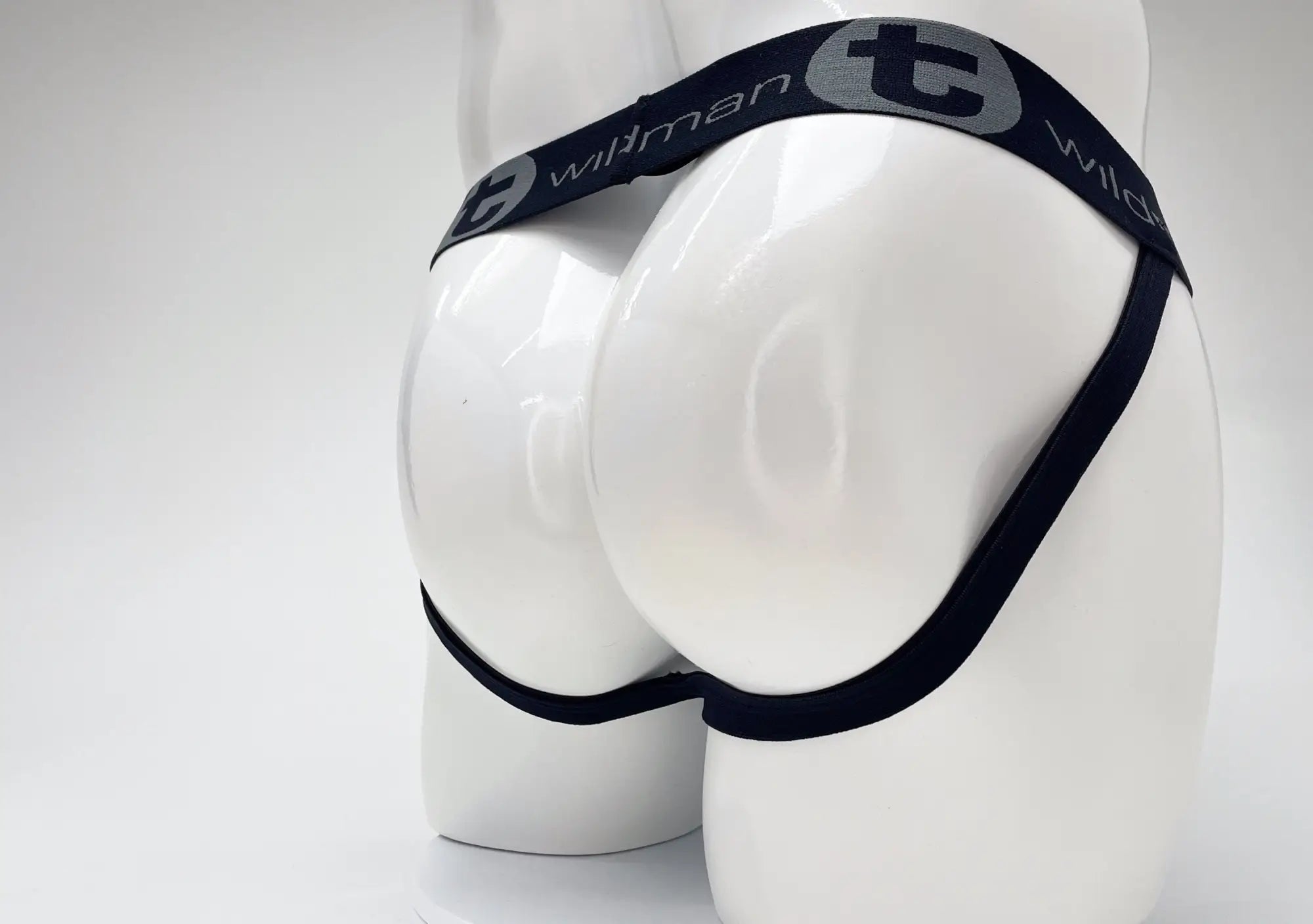 WildmanT jockstrap on a white mannequin, featuring a dark waistband with grey "WildmanT" branding.
