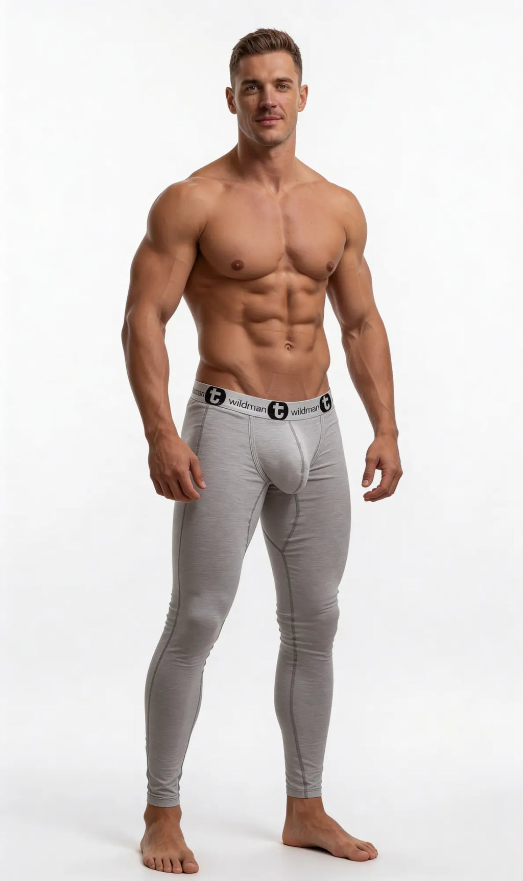 Muscular man wearing heather gray WildmanT long johns featuring a supportive pouch and branded elastic waistband.