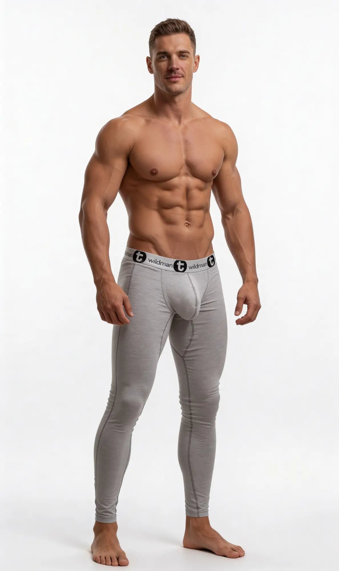 Muscular man wearing heather gray WildmanT long johns featuring a supportive pouch and branded elastic waistband.
