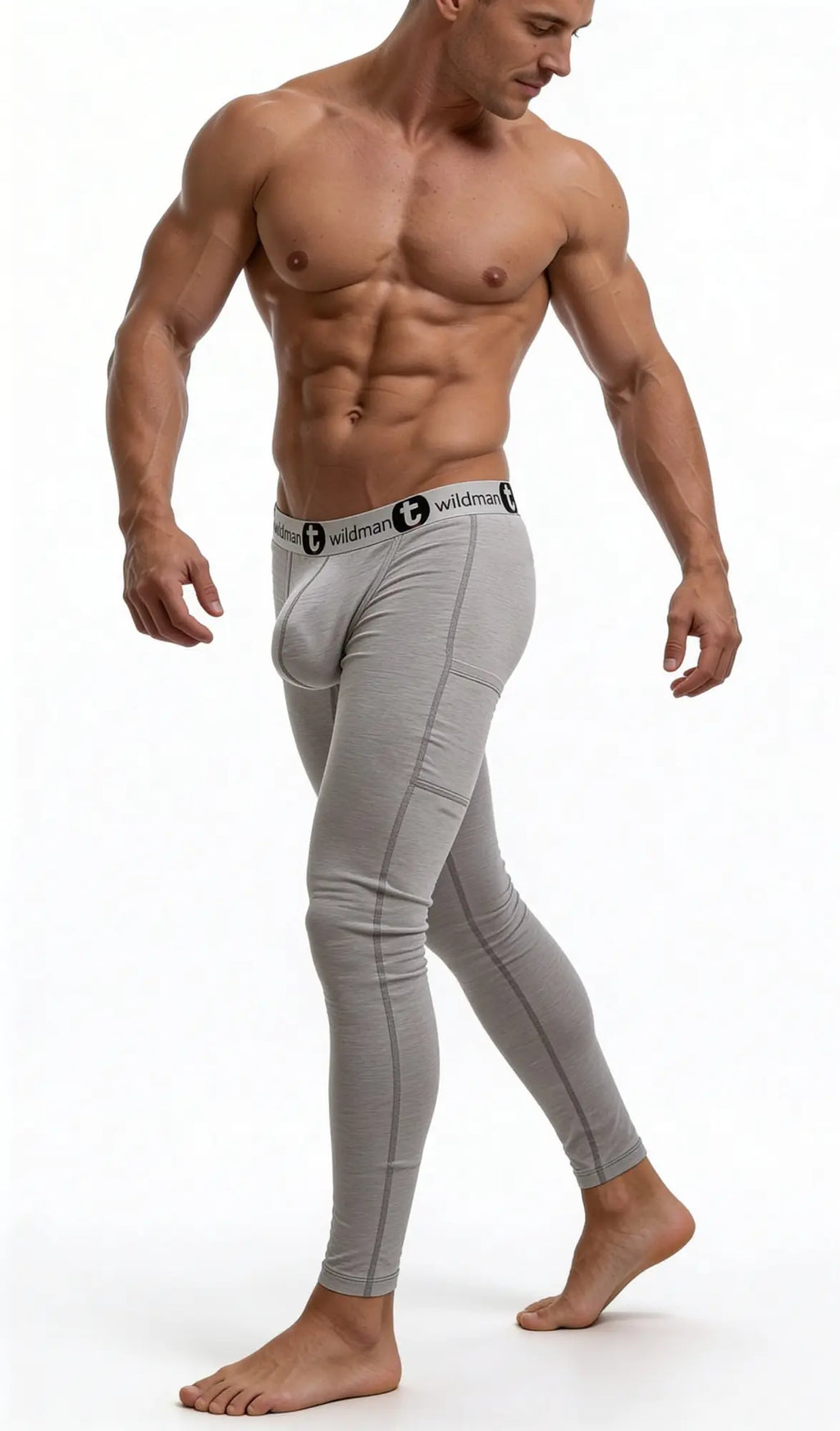 Muscular man wearing heather gray WildmanT Big Boy pouch long johns with a branded black-and-white elastic waistband.