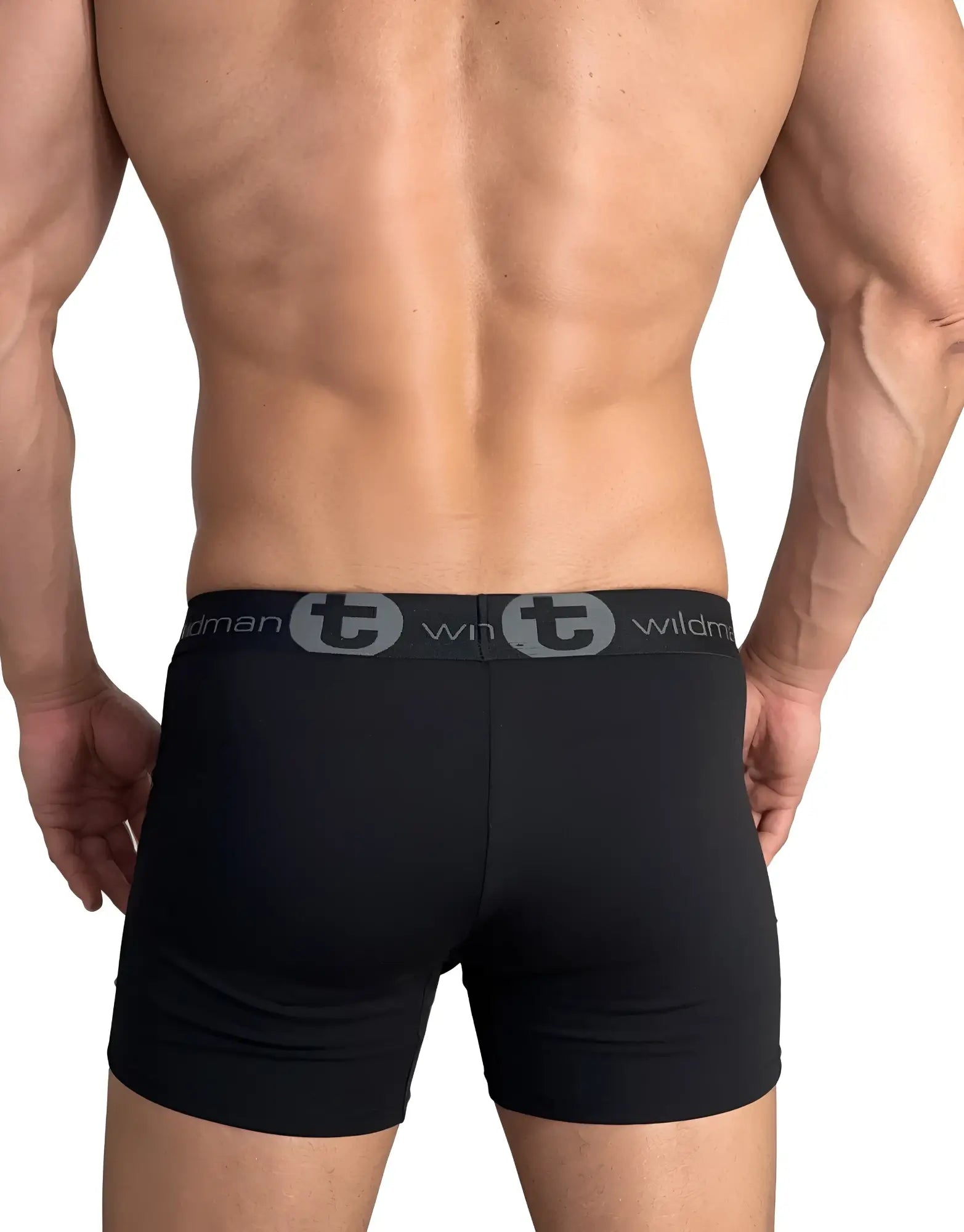 Back view of a muscular man wearing black WildmanT boxer briefs with a branded grey logo waistband.