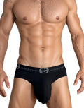 Black WildmanT cotton brief with a contoured pouch and a branded elastic waistband on a muscular male model.