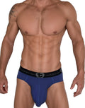 WildmanT dark blue cotton brief with a black elastic waistband featuring the brand logo, worn by a muscular man.