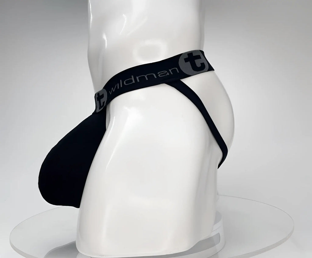 Black WildmanT cotton jockstrap on a mannequin, featuring a large contoured pouch and branded elastic waistband.