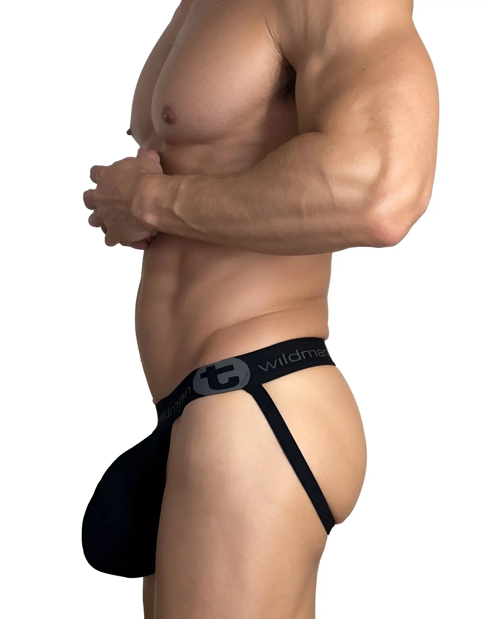 Side view of a man wearing a black WildmanT cotton jockstrap with a branded logo waistband.