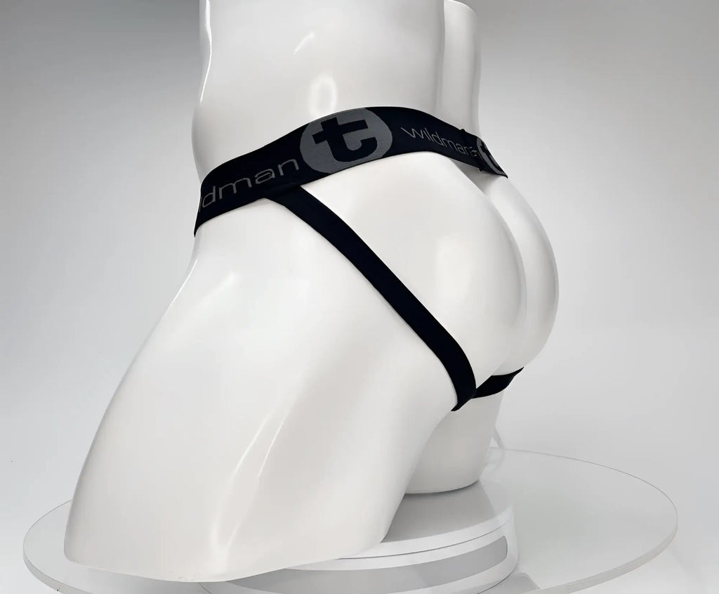 Black WildmanT jockstrap on a white mannequin, featuring a branded elastic waistband with a "T" logo.