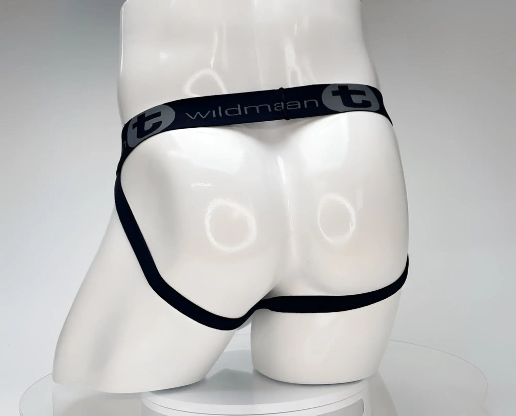 White WildmanT jockstrap on a mannequin, featuring a black branded waistband with the WildmanT logo.