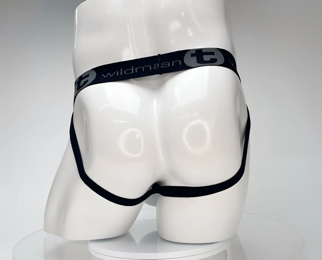 White jockstrap on a mannequin, featuring a black elastic waistband with the grey WildmanT logo and brand name.
