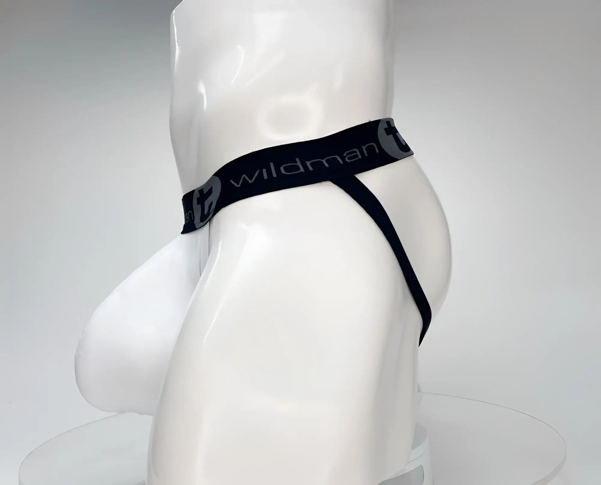 White WildmanT cotton jockstrap with a contoured pouch and black branded waistband on a mannequin.
