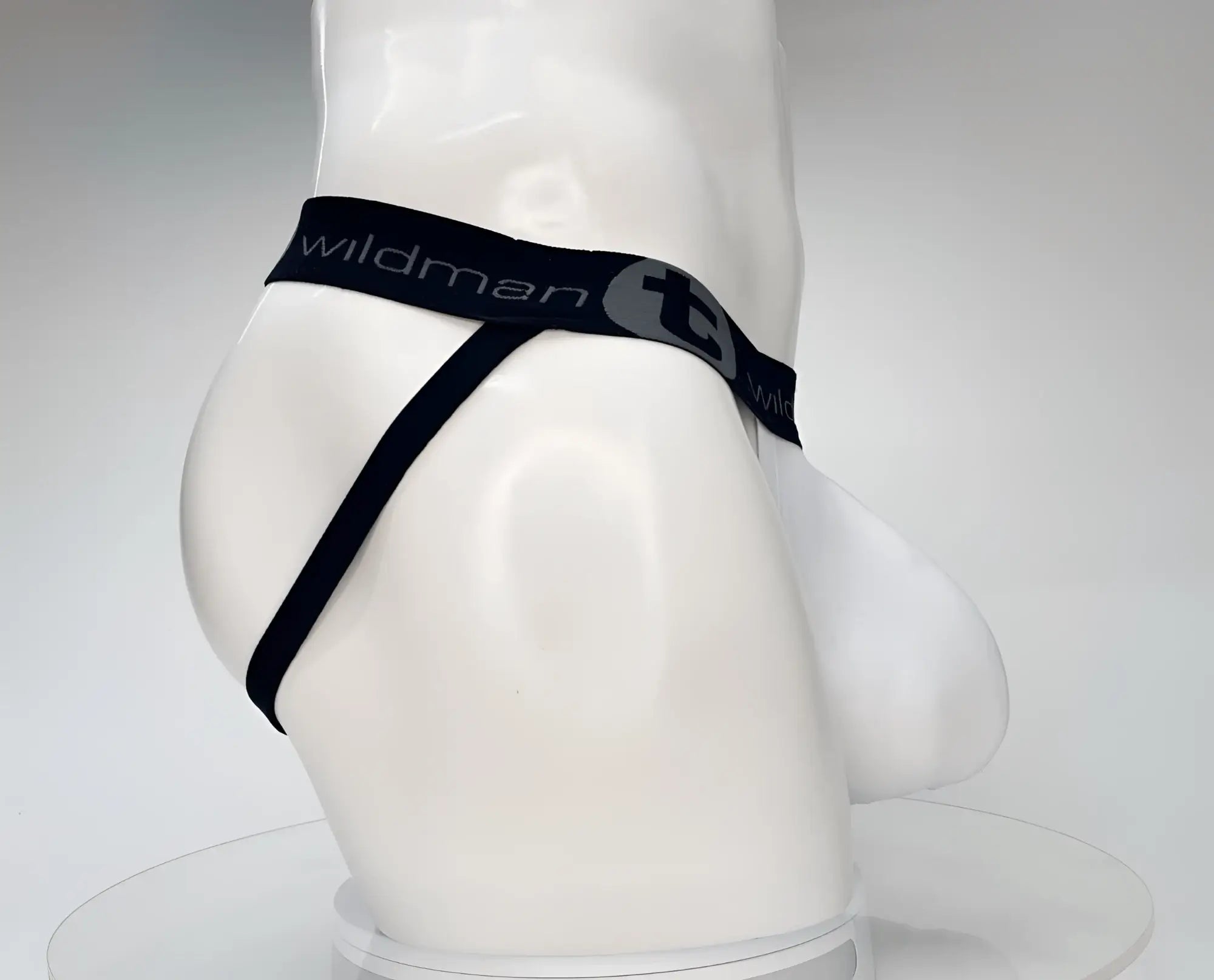 White WildmanT jockstrap with black branded elastic waistband and a contoured front pouch on a mannequin.