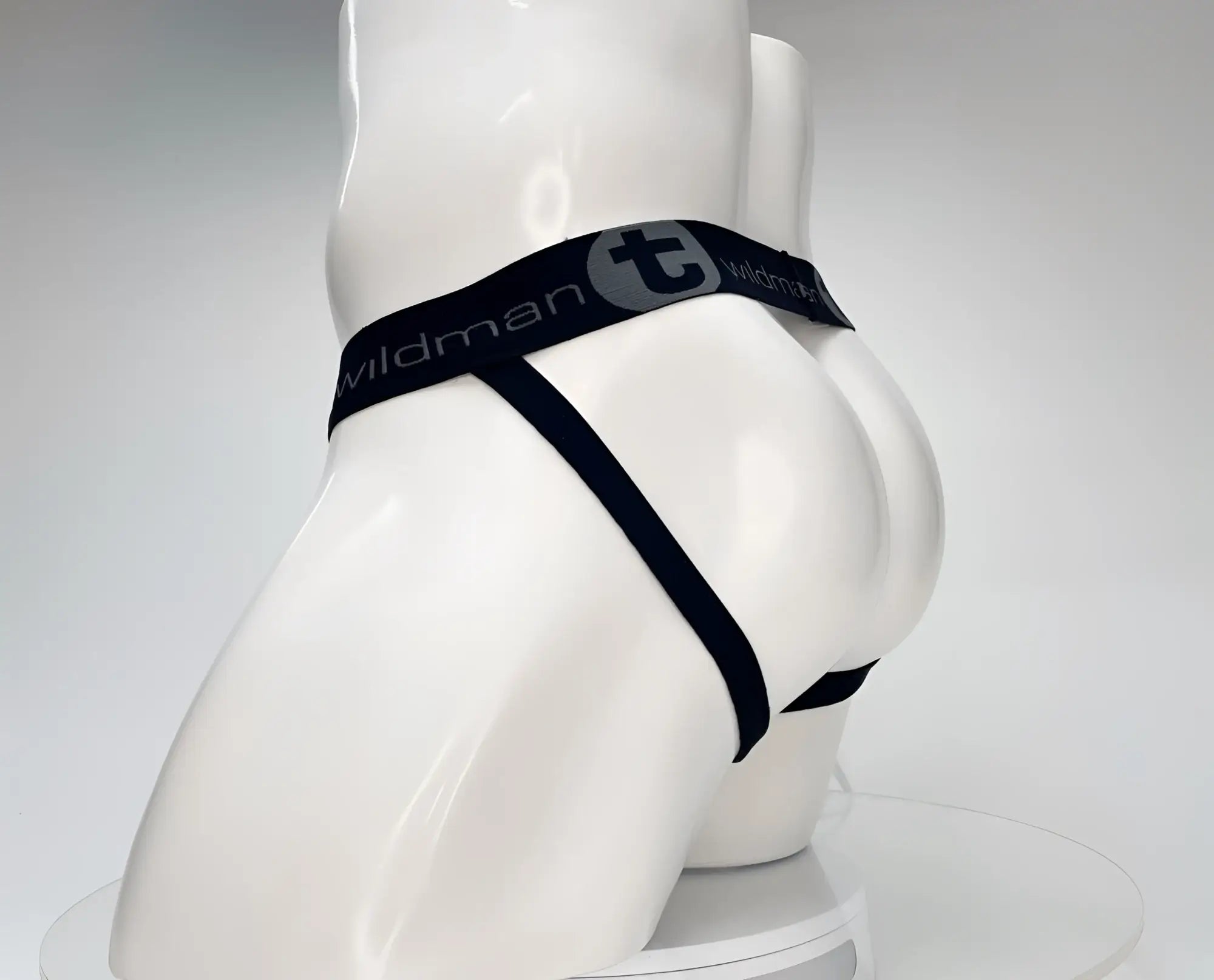 WildmanT black jockstrap with elastic waistband featuring the brand logo on a white mannequin torso.