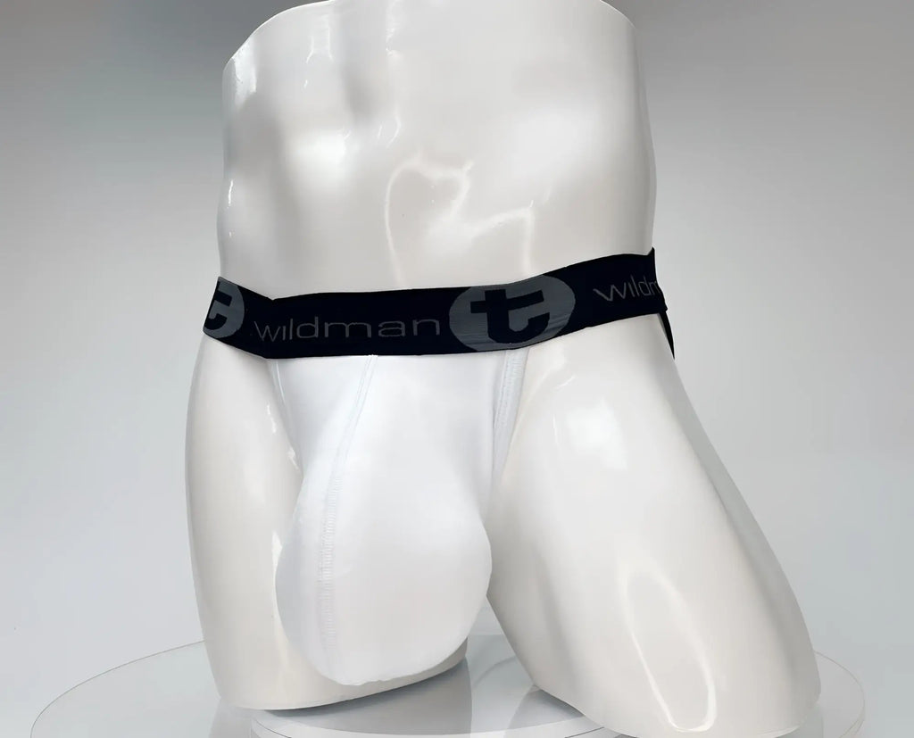 White jockstrap with a contoured pouch on a white mannequin, featuring a black waistband with "wildmanT" branding.