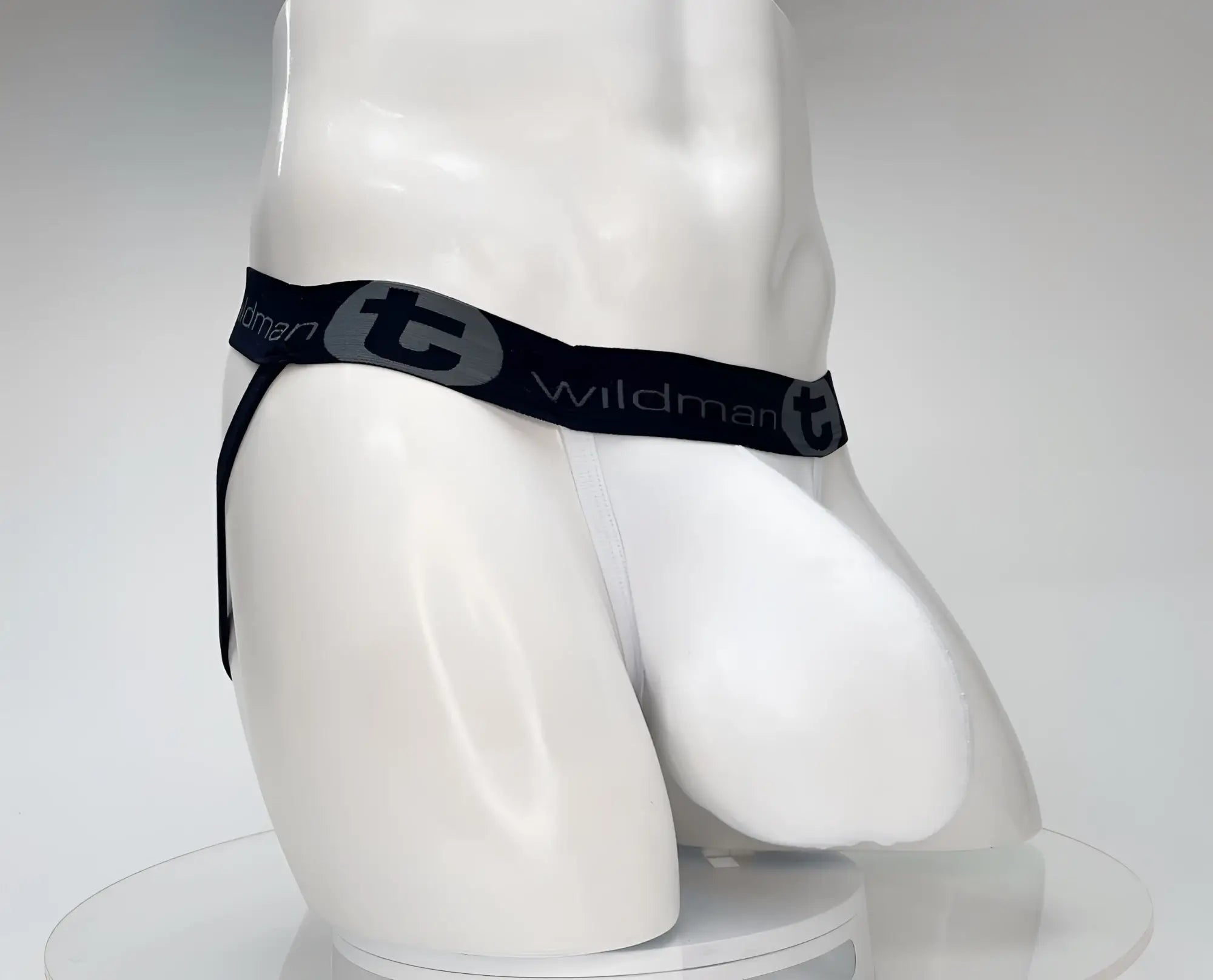White cotton jockstrap with an enhanced-fit pouch and a black waistband featuring the "WildmanT" logo.