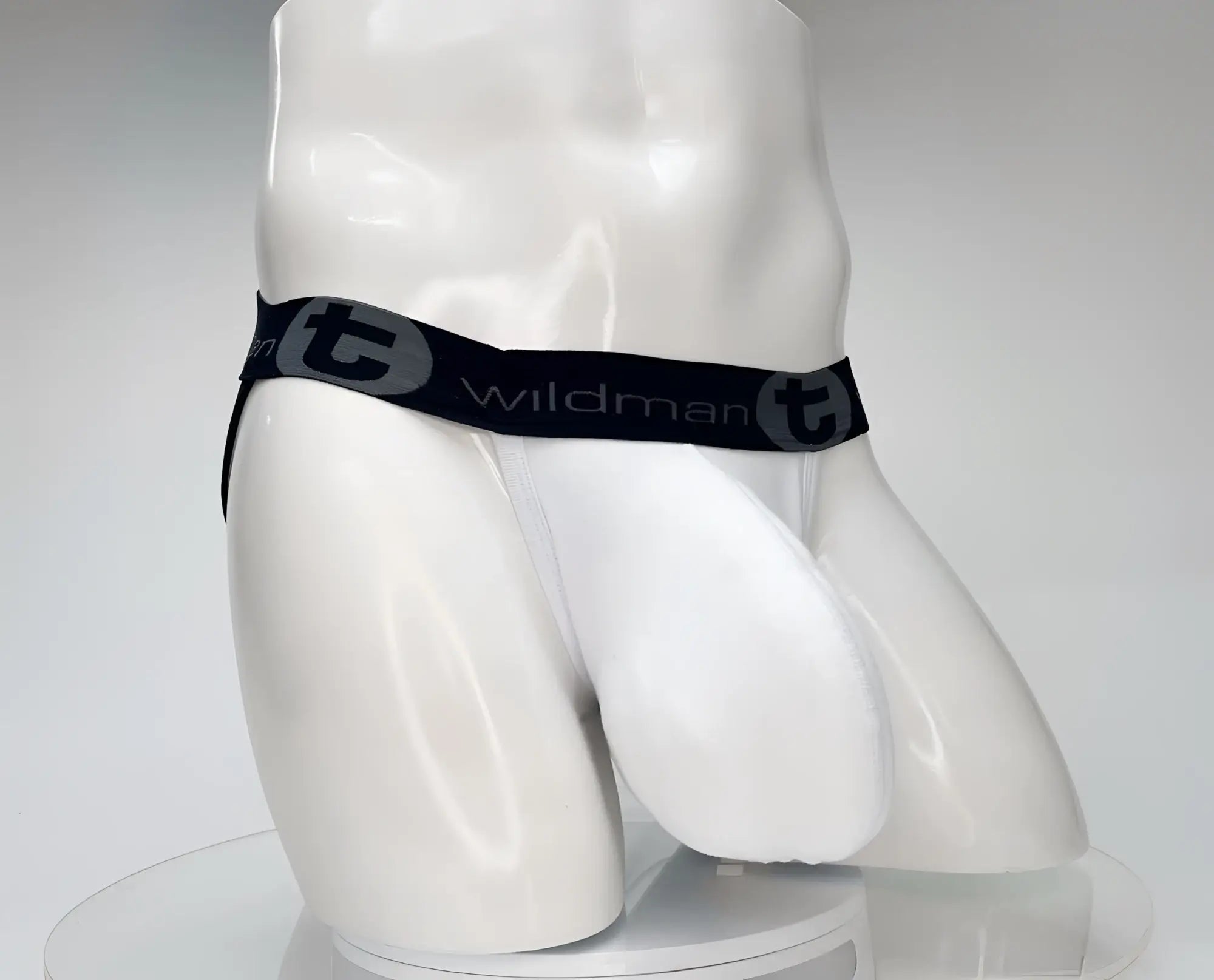 White WildmanT cotton jockstrap on a mannequin, featuring a black waistband with "wildman t" branding.