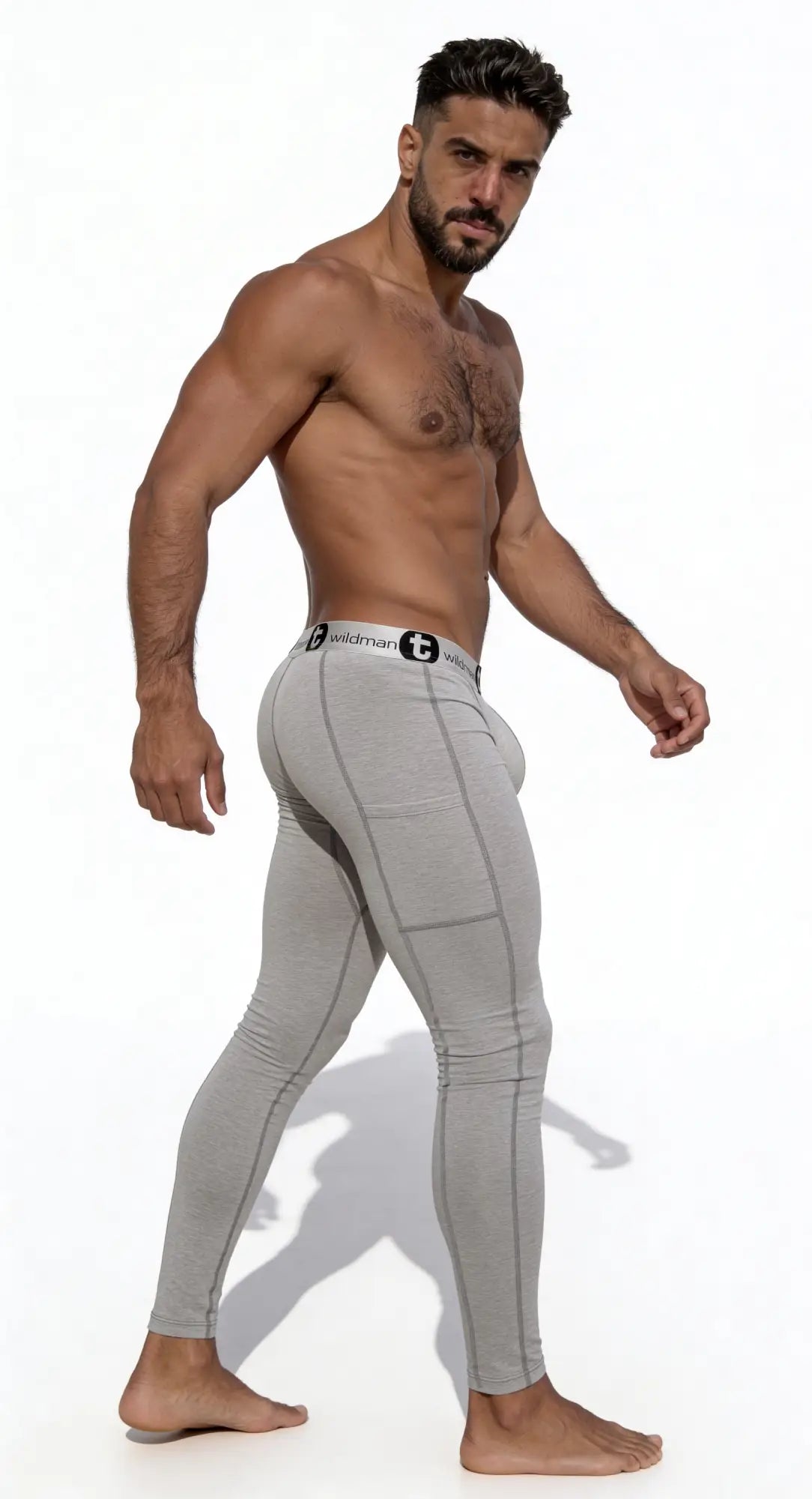 Man wearing WildmanT grey cotton long johns with a fitted pouch and logo waistband, shown from a side profile.