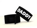 Two black adjustable fabric cock rings with white "DADDY" text and Velcro closures against a white background.