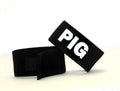 Black, adjustable fabric cock ring featuring a velcro closure and the white embroidered text "PIG" on the front.