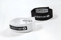 Two WildmanT Max adjustable rings in black and white with Velcro fasteners and branded labels on a white background.