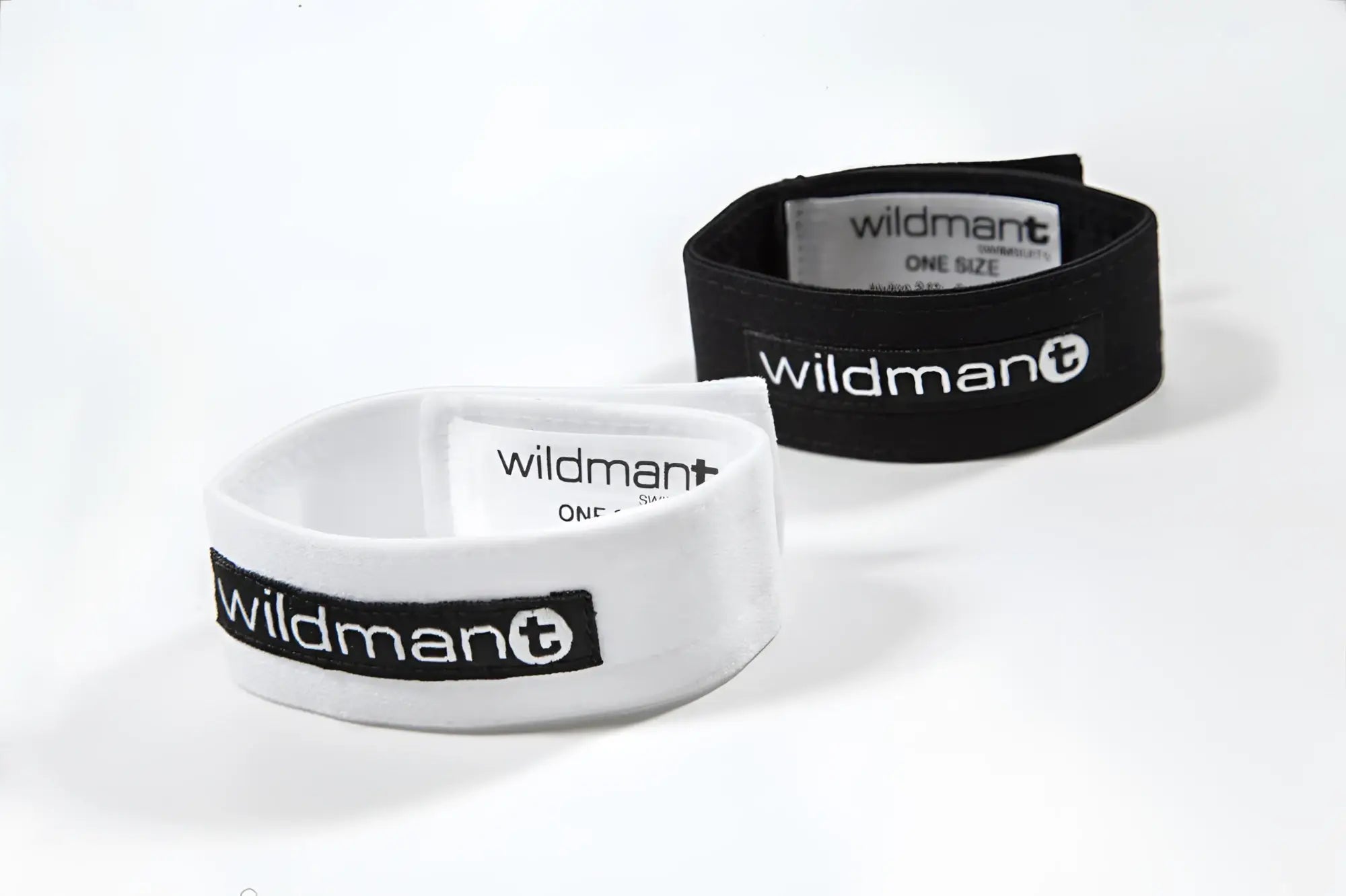 Two WildmanT Max adjustable rings in black and white with Velcro fasteners and branded labels on a white background.