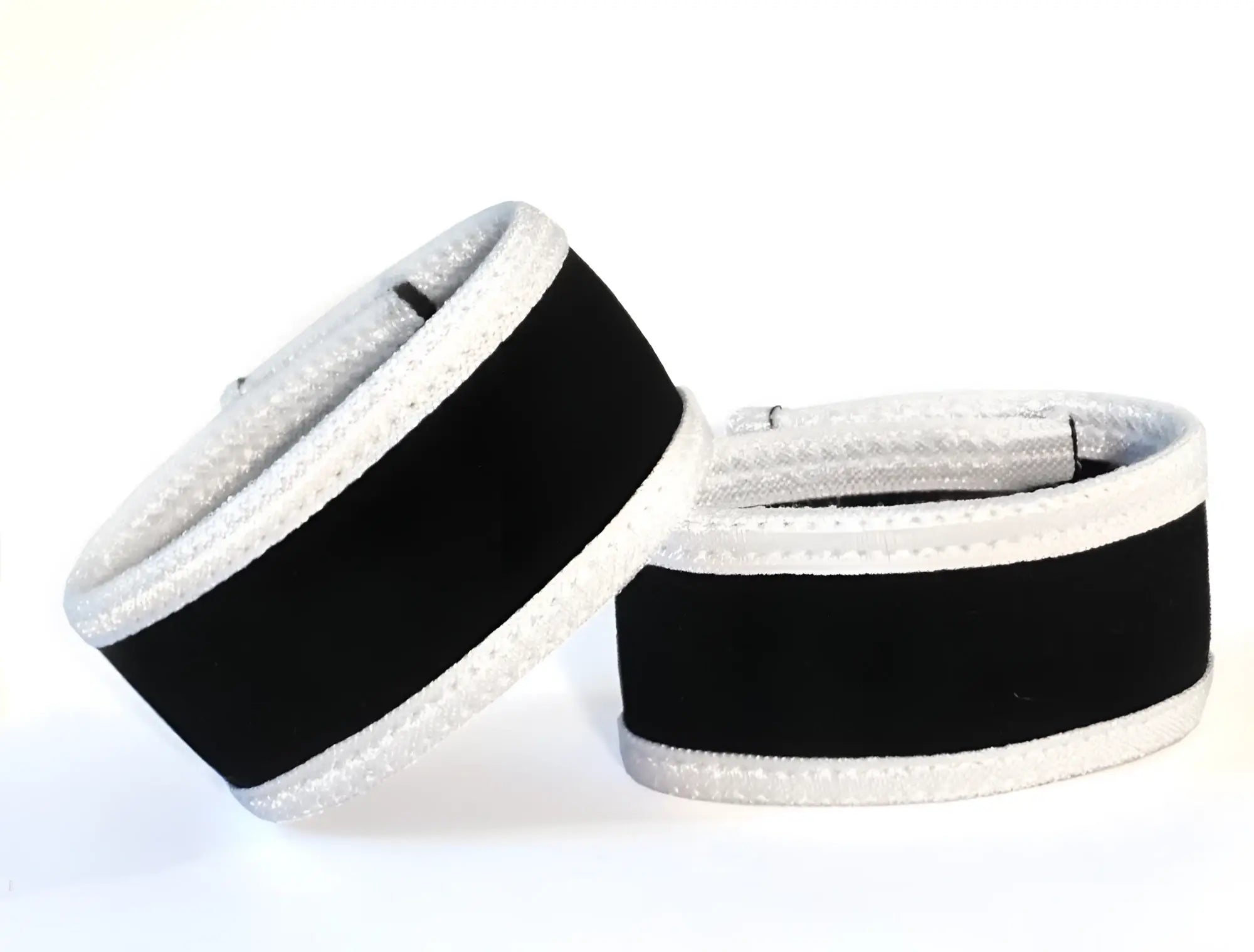 Two WildmanT Max rings in black fabric with prominent white trim, set against a plain white background.