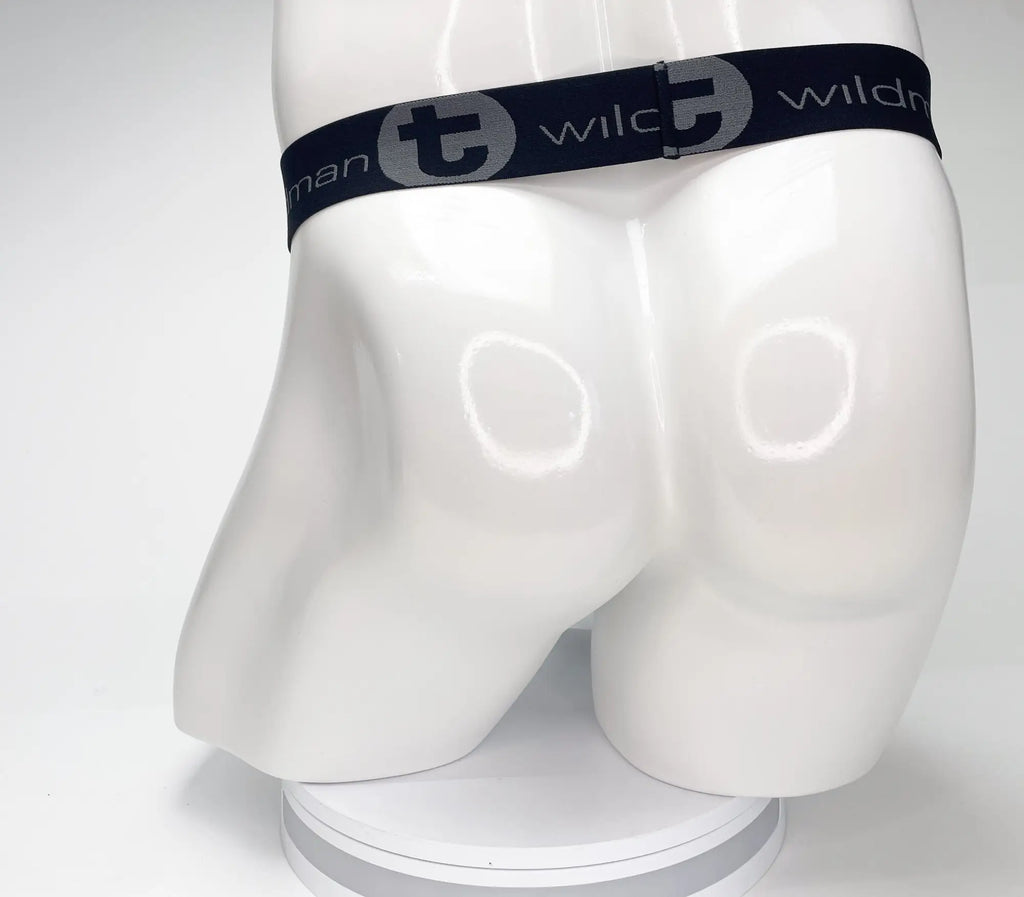 Black waistband with "WildmanT" logo on a white mannequin torso, showing the rear view of a strapless pouch garment.