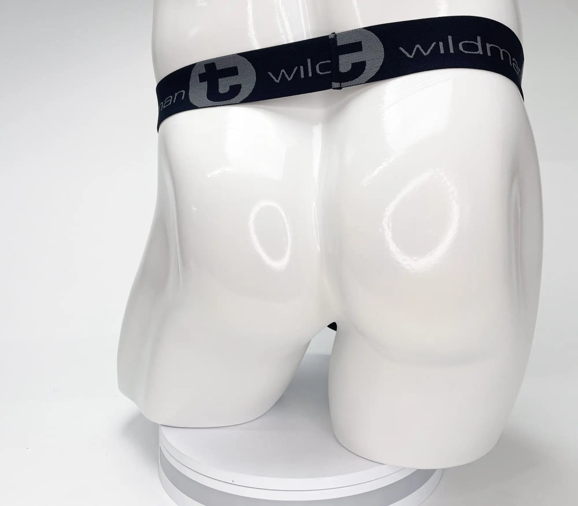 Black WildmanT strapless pouch on a white mannequin, featuring a black elastic waistband with grey branded logo text.