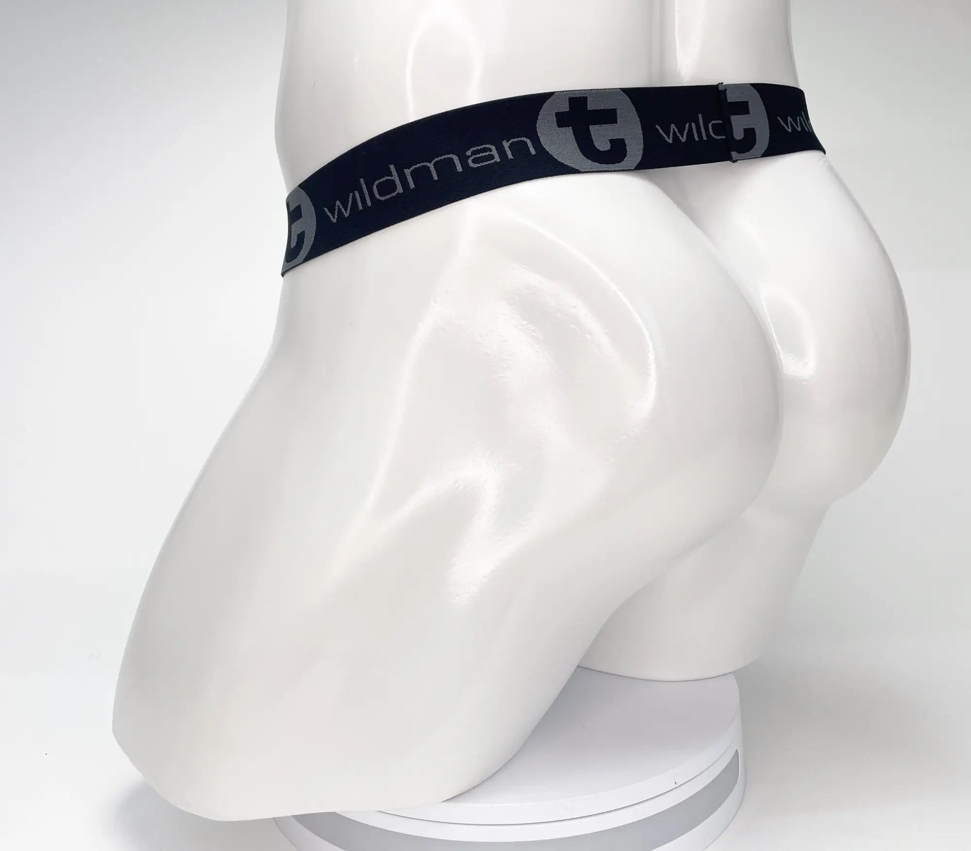 Black WildmanT strapless jockstrap featuring a branded elastic waistband on a white mannequin torso.