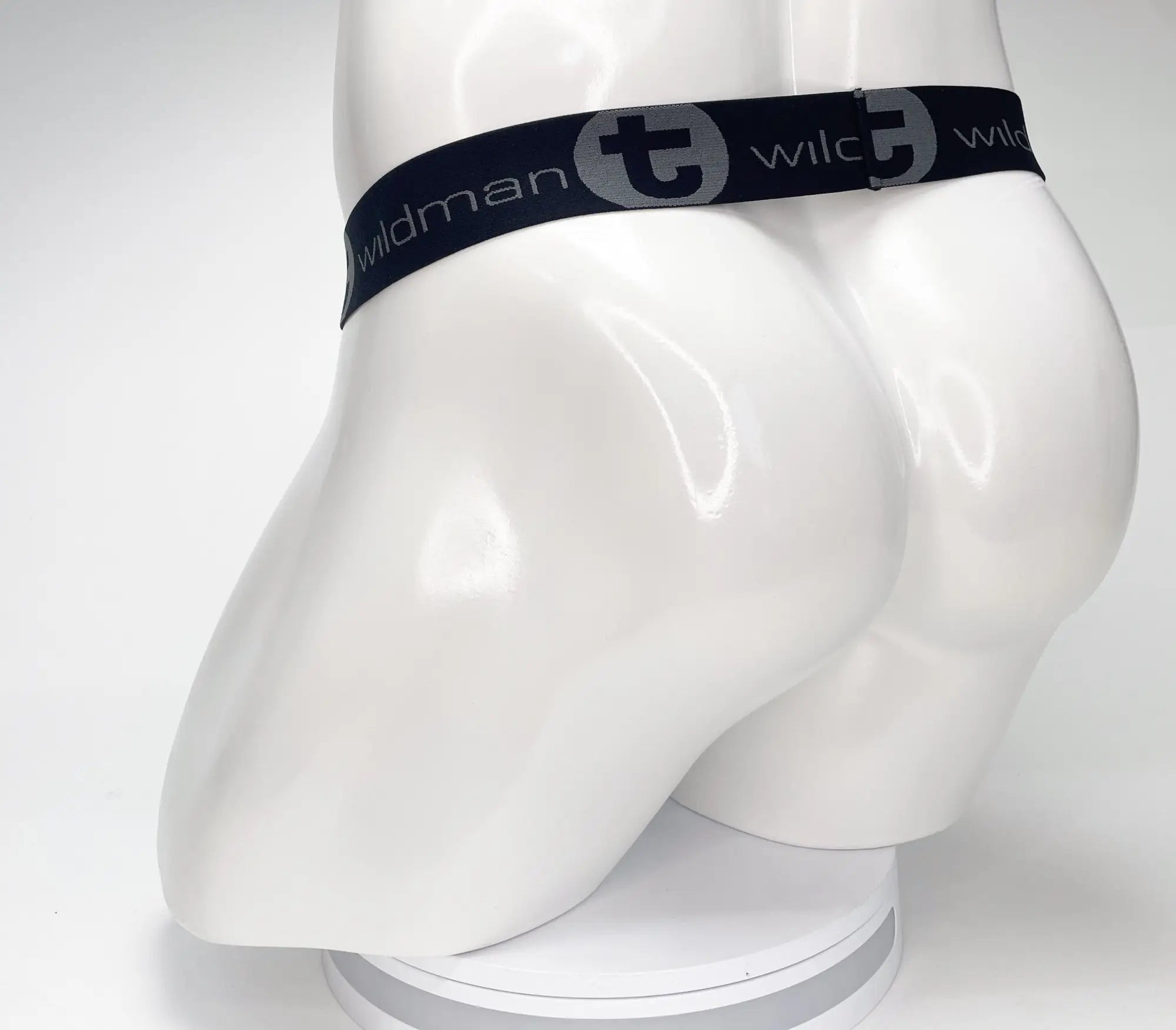 Black WildmanT strapless mesh jockstrap on a white mannequin, featuring a branded waistband with a large logo.