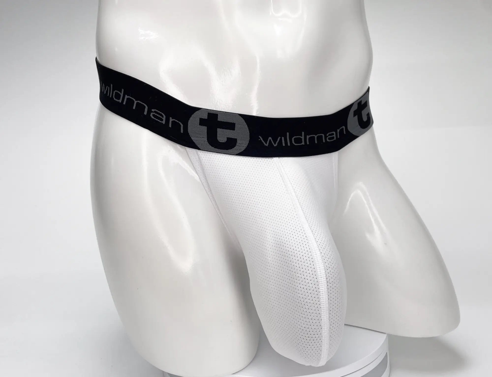 White WildmanT mesh strapless pouch on a mannequin, featuring a black branded elastic waistband with a "t" logo.