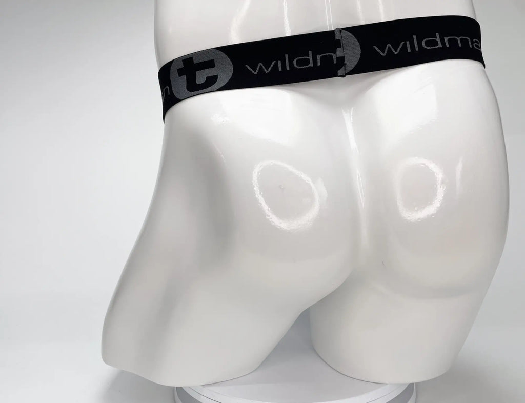 White male mannequin wearing a WildmanT black elastic waistband with grey branded lettering.
