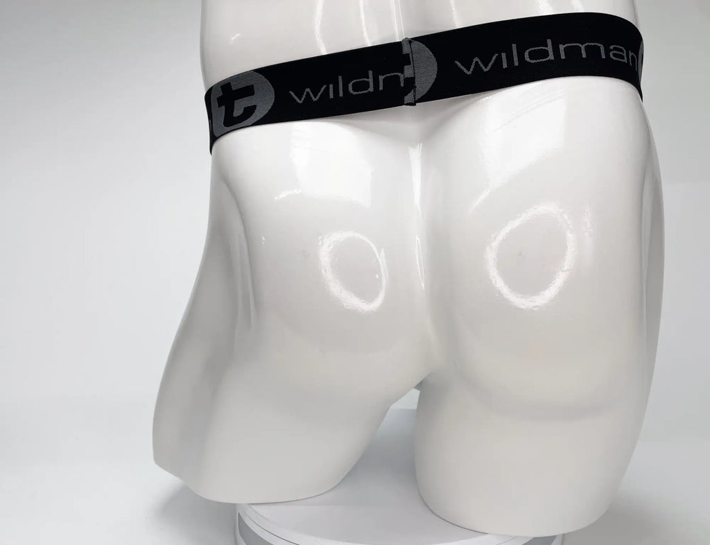 White WildmanT strapless mesh pouch on a white mannequin torso with a black elastic logo waistband.