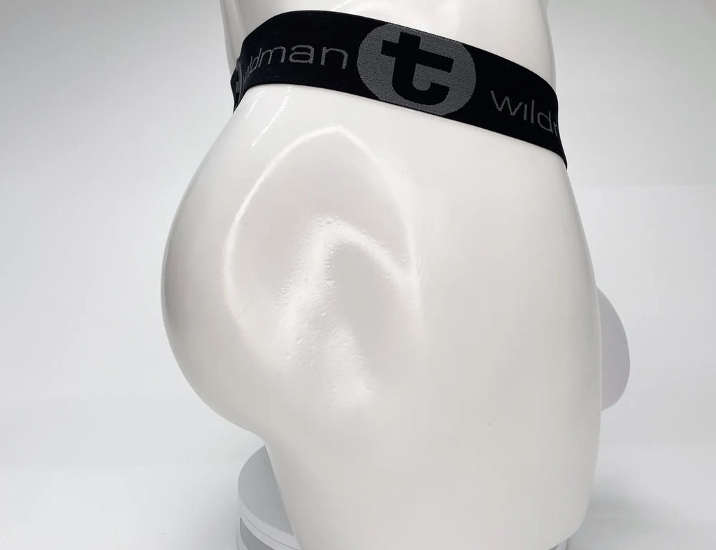White WildmanT mesh strapless pouch worn on a white mannequin with a black elastic waistband featuring logo branding.