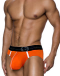 WildmanT orange modal pouch brief with white accents and a branded black waistband on a muscular model.