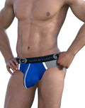WildmanT royal blue Modal Big Boy pouch brief with a grey waistband and white trim, worn by a muscular man.