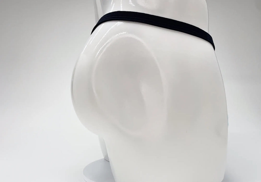 Baby blue micro thong with a thin black waistband on a white mannequin torso, viewed from the side and back.