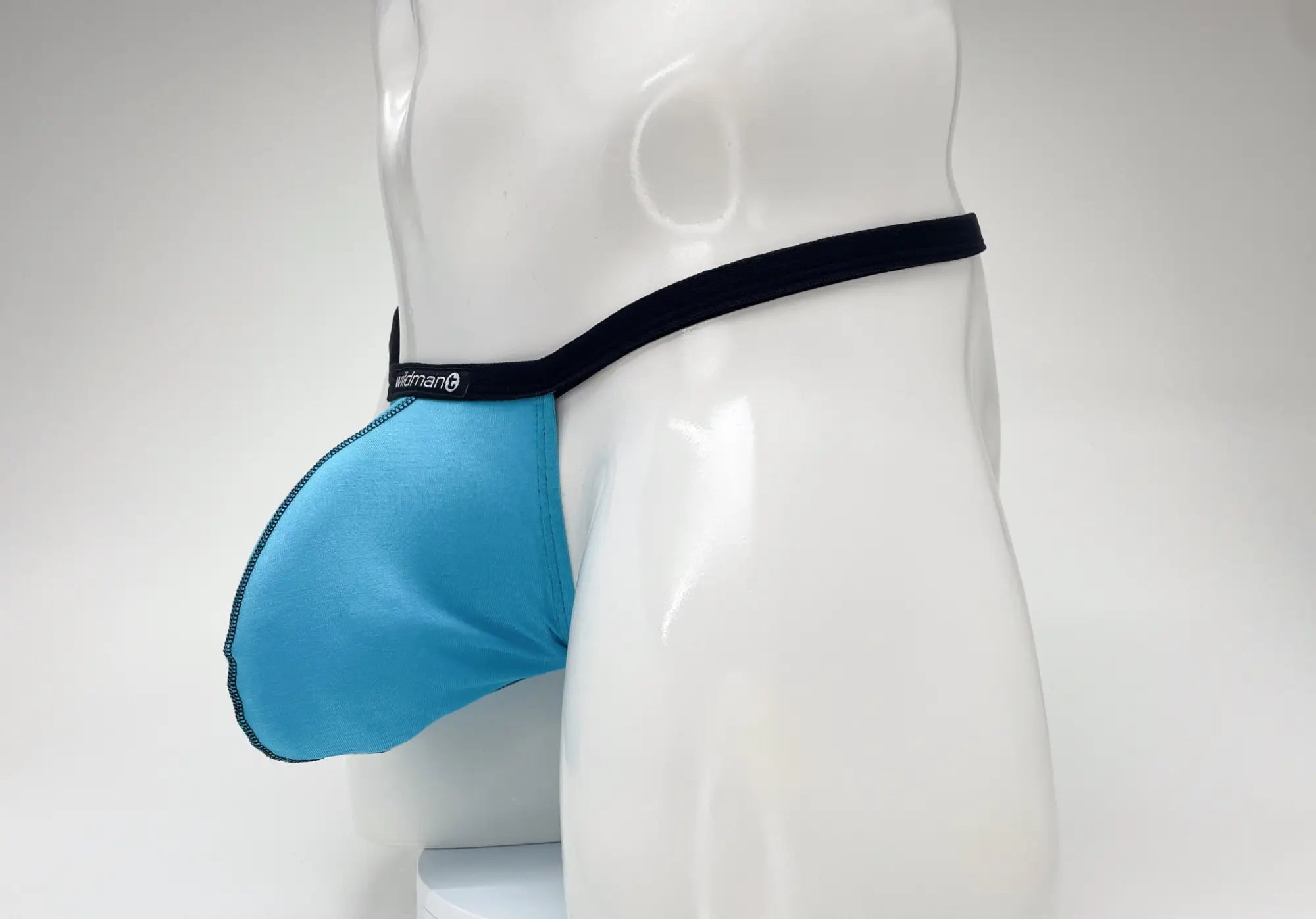 Baby blue modal micro thong with a prominent pouch and black trim, displayed on a white mannequin torso.