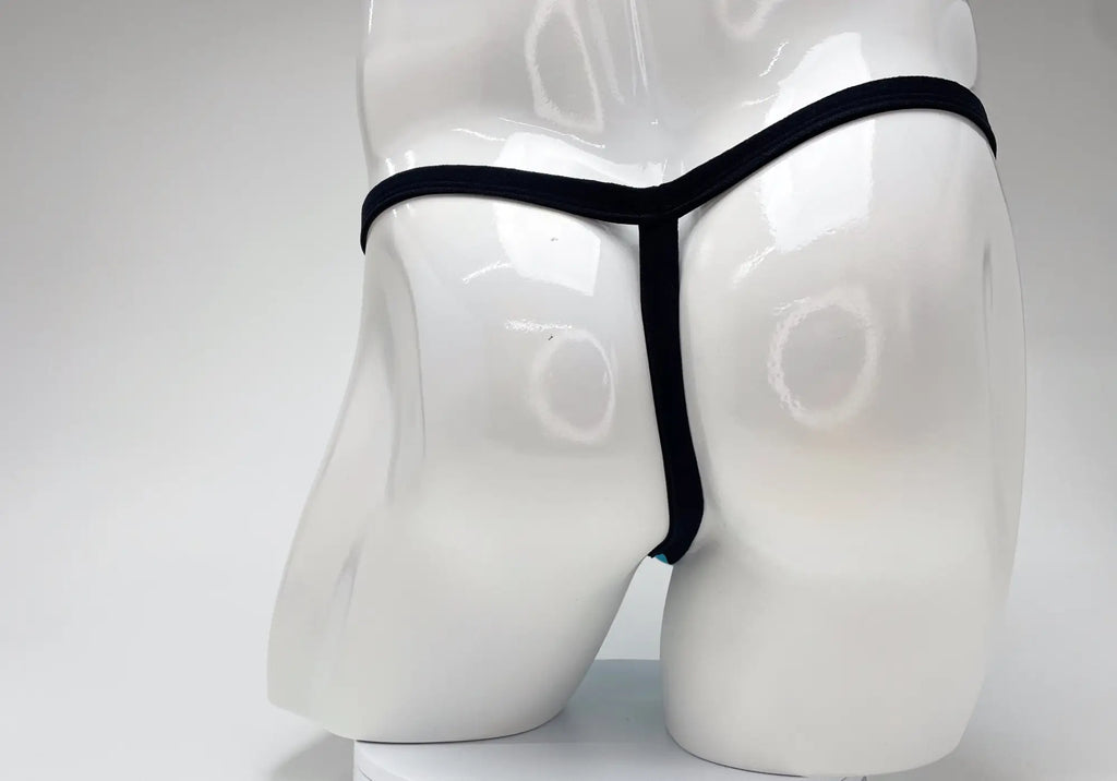 Back view of a baby blue modal micro thong with thin black elastic trim on a white mannequin.