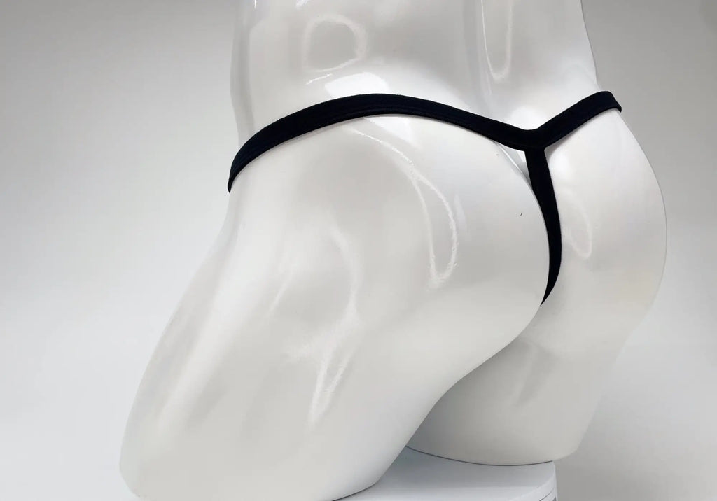 Back view of a white male mannequin wearing a black minimalist micro thong.