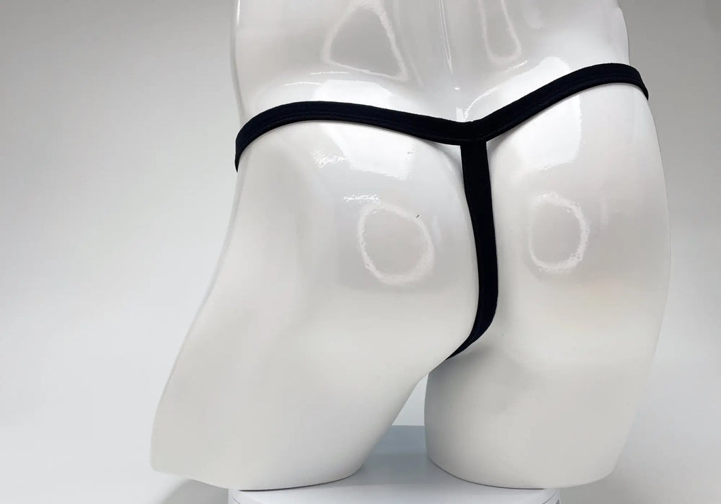 Back view of a black thin-strap thong on a glossy white male mannequin torso.