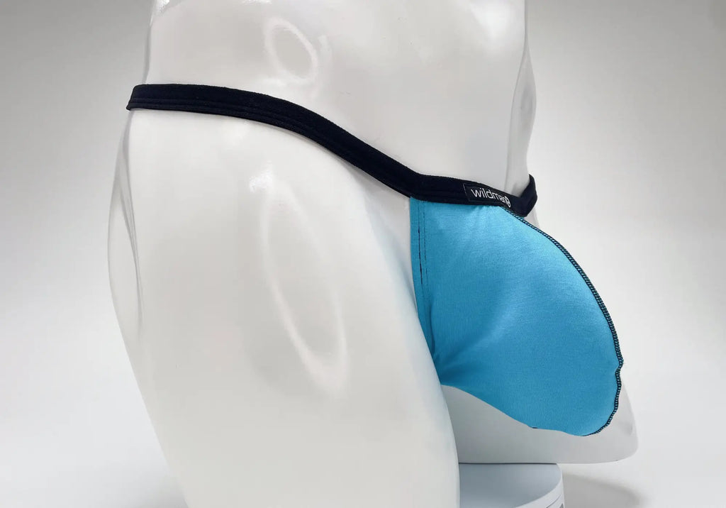 Baby blue WildmanT Modal micro thong with a big boy pouch and contrasting black waistband on a white mannequin.