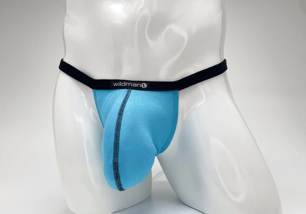 Baby blue WildmanT modal micro thong with a large pouch, black waistband, and black contrast stitching on a mannequin.