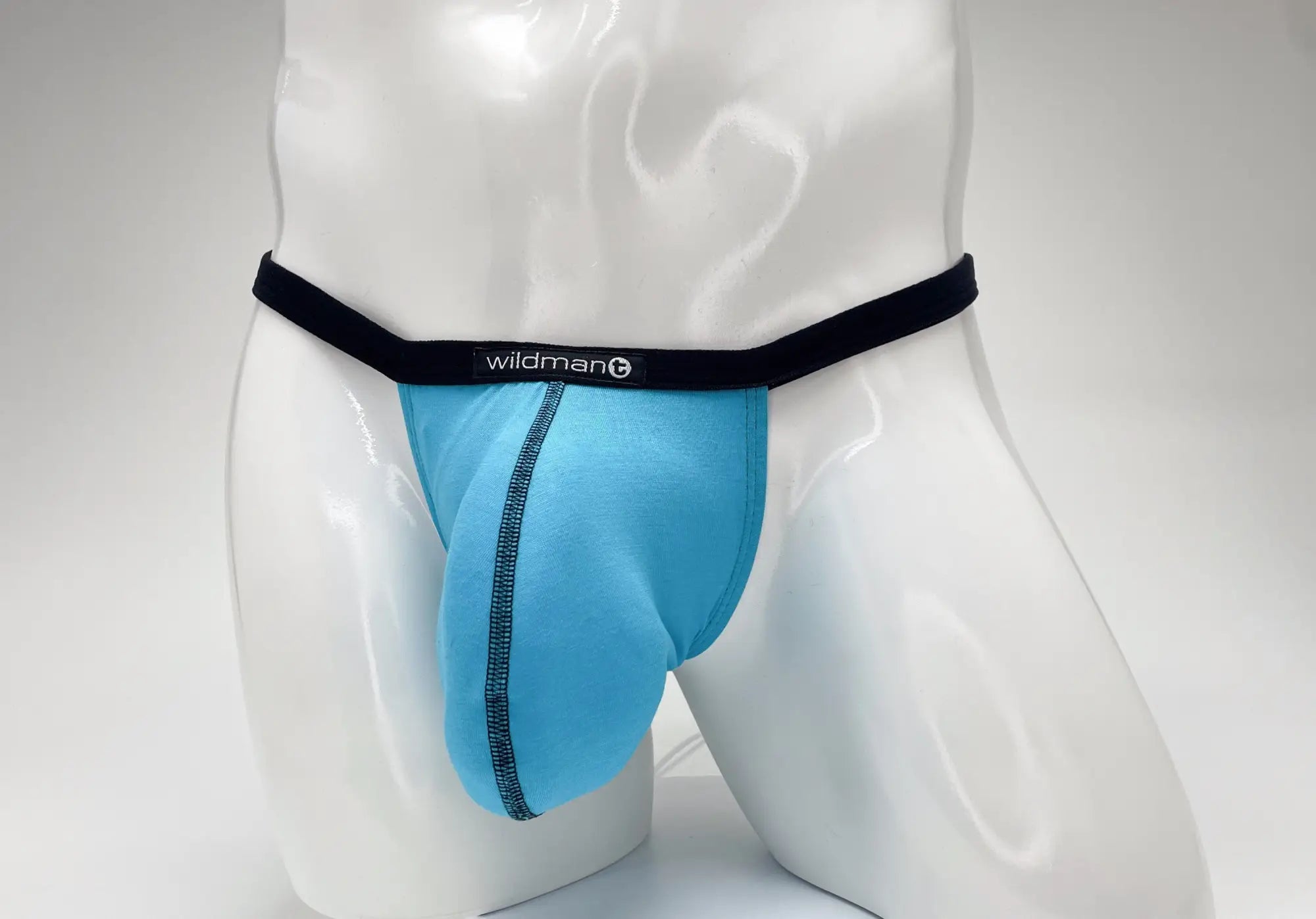 Baby blue WildmanT modal micro thong with a large pouch, black waistband, and black contrast stitching on a mannequin.