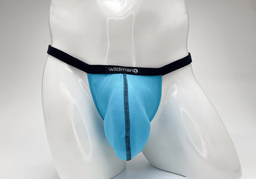 Baby blue WildmanT micro thong with a prominent pouch, black waistband, and logo centered on a white mannequin torso.