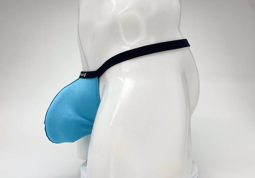 Baby blue WildmanT micro thong with a prominent pouch and black trim, worn by a white male mannequin.