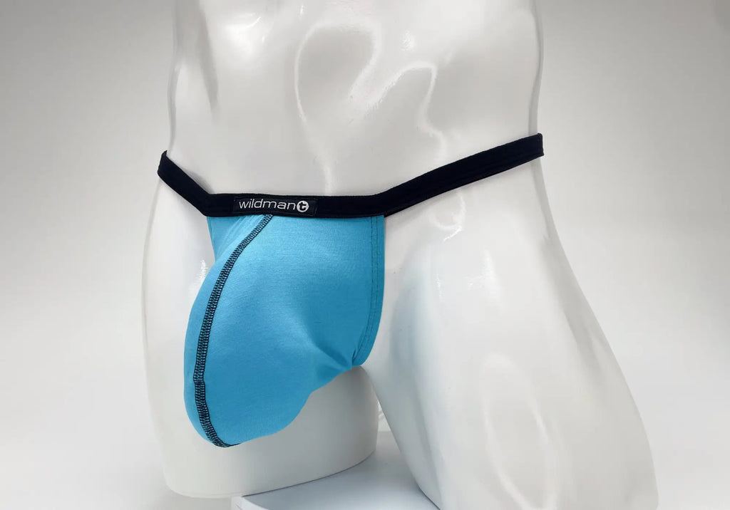 Baby blue WildmanT micro thong with a prominent pouch, black waistband, and logo tag on a white male mannequin.