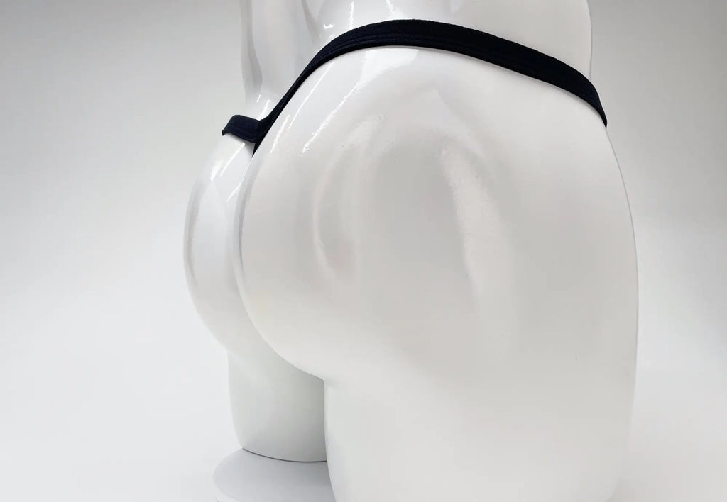 Back view of a white mannequin wearing a minimal black thong with a thin waistband against a white background.
