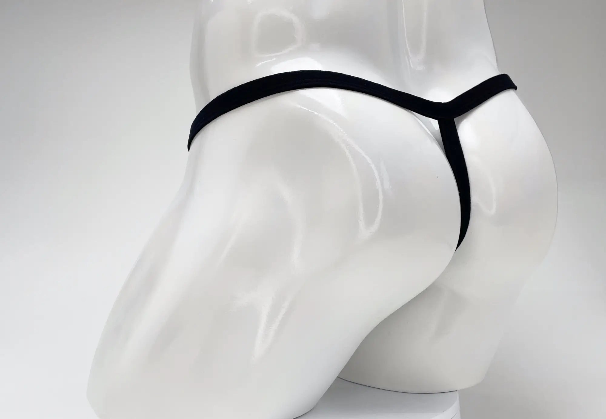 Black WildmanT modal micro thong viewed from the rear on a white mannequin.