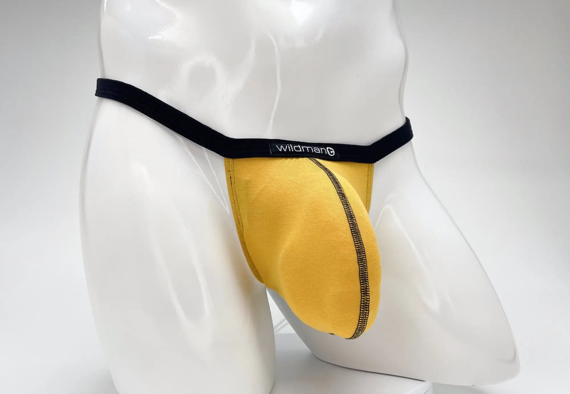 Gold modal micro thong with a large pouch, black waistband, and contrast stitching on a white mannequin torso.